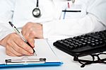 physician-writing-prescription-100202681